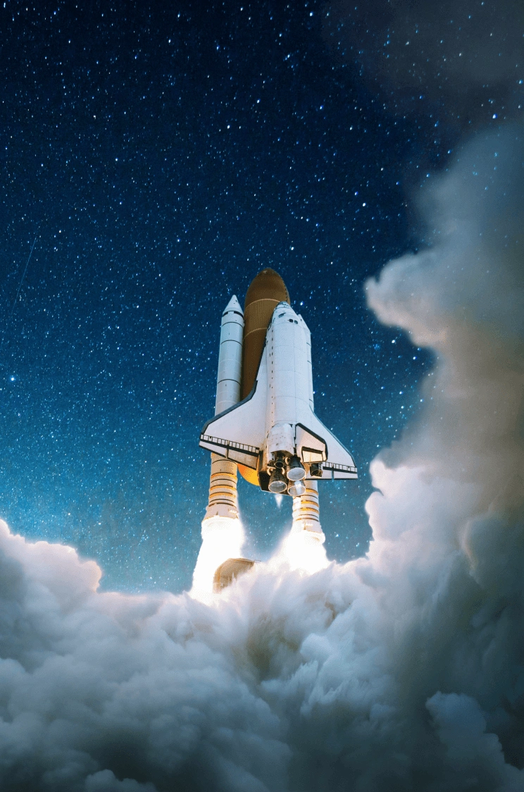 A space shuttle launching through cloud into a starry sky